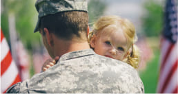 A soldier hugging a baby